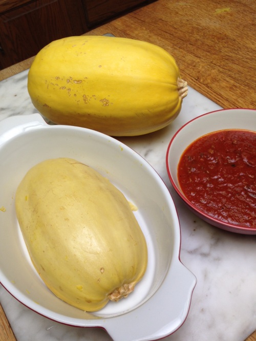 The pale yellow half-squash is cooked. The meaty red sauce is low-carb.